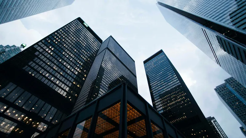 Low angle photo of city high rise buildings during daytime by Sean Pollock