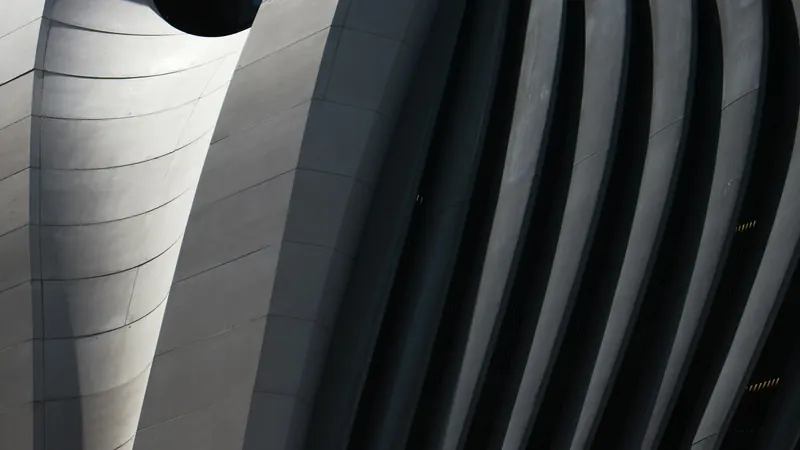 White and black concrete building by Ussama Azam